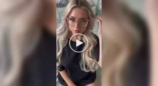 Blonde girl with glasses lay down on the bed