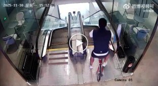 A Chinese man attempts to ride a bicycle Escalator