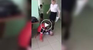 In Russia, a teacher kicked a schoolboy and dragged him across the floor to stop a fight