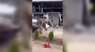 A guy jumps into a crowd of special forces beating his father.