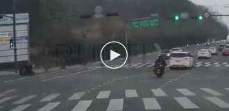 Car and motorcycle fall into sudden hole in road