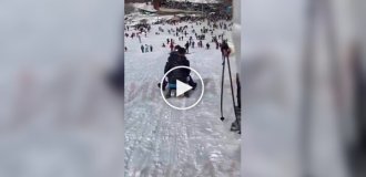 In Kosovo, two guys on a sled at full speed hit a girl