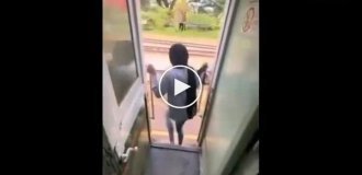 A girl, posing in the doorway of a departing train, got hit in the head with a pole