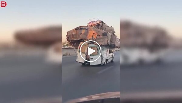 A car, loaded to the brim with cardboard, burst into flames on the side of the road