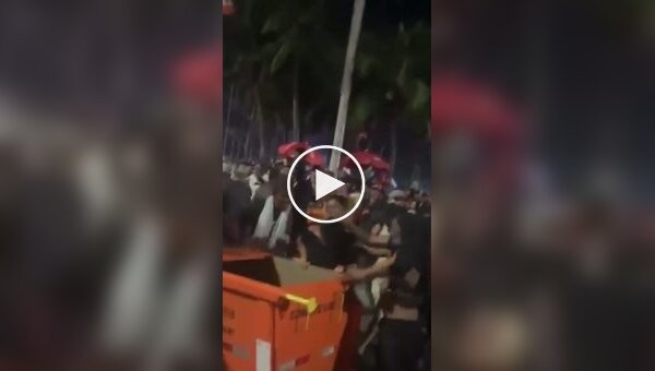 Concert goers put a pickpocket in a trash container