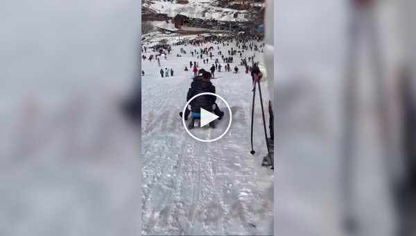 In Kosovo, two guys on a sled at full speed hit a girl