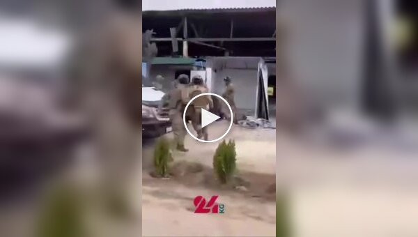 A guy jumps into a crowd of special forces beating his father.