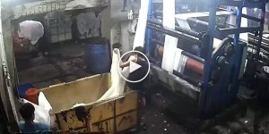 At an Indian garment factory, a young man tried to untangle stuck fabric by wrapping it around his head